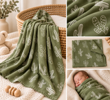 Collage showing an olive green muslin blanket with a white cactus pattern, draped over a woven basket and styled on a knit blanket, with close-up fabric detail and a baby wrapped in the blanket sleeping peacefully.