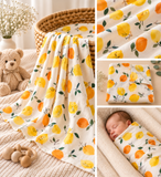 Oranges and lemons muslin baby wrap on beige background. New born baby wrapped in soft muslin fabric 